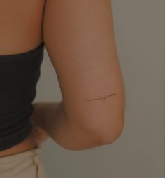 a woman's arm with the word love written in cursive writing on it