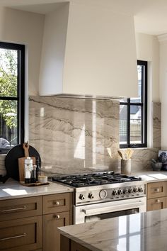 a stove top oven sitting inside of a kitchen next to a counter and cabinets with drawers