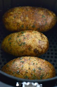 three potatoes in a pot with seasoning sprinkled on them