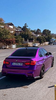 a purple car is parked in the parking lot