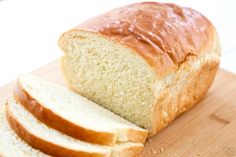 a loaf of bread sitting on top of a wooden cutting board