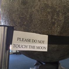 a sign that says please do not touch the moon