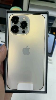 an iphone 11 pro in its box with the camera facing up on it's side