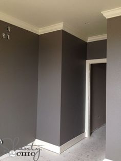 an empty room with gray walls and white trim on the walls is seen in this instagram photo