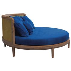 a blue chaise lounge chair with pillows on it's back and arms, against a white background