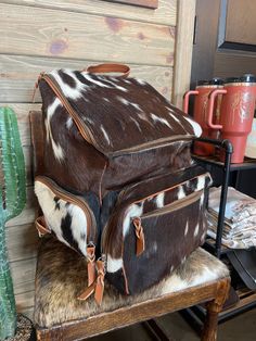 This backpack is HUGE!! it’s perfect for a diaper bag or your airport travel bag! It has a ton of room and so many pockets making this the perfect useful bag for traveling or making sure you have everything for your kiddos! Backpack measures approximately 13” x 18” x 17” Genuine cowhide 2 front pockets, side pocket on each side both inside and outside. Card slots & zipper pocket on the inside as well! LAST PICTURE IS FOR SIZE REFERENCE ON We show the EXACT hide here so you know what you’re getti Brown Backpack For Weekend Trips, Weekender Backpack With Luggage Sleeve, Rectangular Travel Backpack With Multiple Pockets, Travel Diaper Bag With Zipper Pocket, Brown Backpack Diaper Bag For Travel, Standard Backpack Diaper Bag With Removable Pouch, Airport Travel Bag, Western Bookbags, Western Backpack Purse