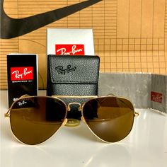 Ray Bans Are Foldable With The Box And Case Color Frame Is Gold And Glass Is Black. The Sunglasses Are Brand New With No Damage, What You See Is What You Get. Gold Aviator Sunglasses With Uva Protection, Gold Aviator Sunglasses With Polarized Lenses, Classic Gold Aviator Sunglasses With Glass Lenses, Folding Sunglasses, Color Frame, Man Ray, Colored Sunglasses, What You See, The Box