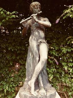 a statue of a woman playing the flute