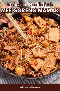 someone holding chopsticks over some noodles in a skillet with the words malaysian noodle dish mee goreng mammak