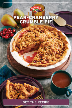 a pie with crumbled toppings on top and two plates next to it