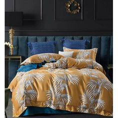 an image of a bedroom setting with palm tree bedding and comforter set on the bed