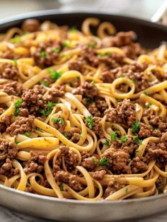 a pan filled with spaghetti and meat sauce