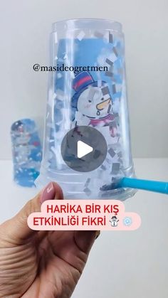 someone is holding up a plastic cup with a snowman on it and the words hakka bir kis