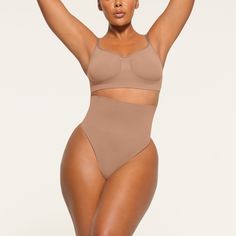 Get ultimate compression with our highest support level in this high-rise shapewear thong that sculpts, smooths, and tones your core and tummy. Wear this silky staple under everything to enhance your natural shape. Features removable adjustable straps. | SKIMS High-Waisted Thong | Medium Neutral | Core Control Shapewear Thong, Thong Shapewear, Cute Lingerie, Tummy Tucks, Natural Shapes, Shapewear, Classic Black, Bones, Adjustable Straps