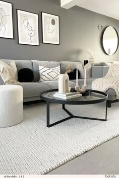 a living room filled with lots of furniture and pictures on the wall above it's coffee table