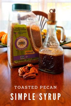 the ingredients for toasted pecan simples syrup on a wooden table in front of a window