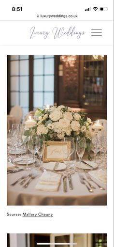 a table set with white flowers and silverware for a formal dinner or wedding reception