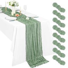 the table is set with place settings and green napkins