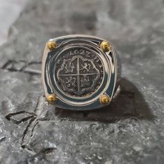 "This is a very classic and beautiful setting. The ring is solid sterling silver and with four points on the top which are a 14kt gold overlay. The coin is made from the silver bars recovered from the Atocha and comes with a certificate stating that the. This particular coin is also dated \"1622\", the year the Atocha sank. A wonderful piece of history. I also sign my name on the back so you know you are getting a JackSpirit original design. Please specify which size you want." Sunken Treasure, Silver Coin Ring, Key West Fl, Coin Ring, Gold Overlay, Ocean Wave, Silver Coin, Shipwreck, Silver Bars