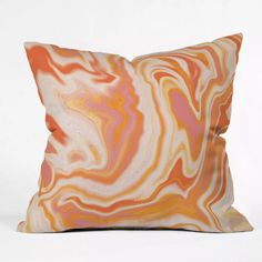 an orange and pink pillow on a white background