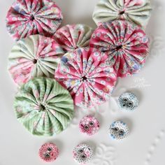 several different types of fabric flowers on a plate