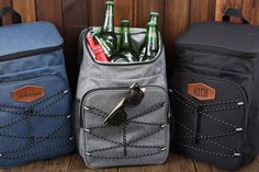 three backpacks with beer bottles in them sitting next to each other