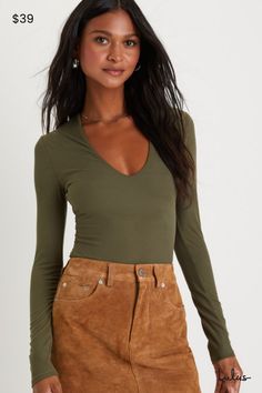 The Lulus Obviously Perfect Olive Green Ribbed V-Neck Bodysuit is an absolute must-have for every babe's closet! Stay comfy and cute in this stretchy ribbed knit bodysuit that features a flattering V-neckline framed by long fitted sleeves. The figure-hugging bodice continues down to attached thong bottoms with snap closures, perfect for tucking into your favorite high-waisted denim! Fit: This garment fits true to size. Length: Size medium measures 30" from shoulder to hem. Bust: Great for any cup size. Waist: Fitted - stretchy fabric allows custom fit. Hip: Fitted - stretchy fabric allows room for hips. Undergarments: May be worn with any standard bra. Fabric: Fabric is very stretchy. Lined. 96% Polyester, 4% Spandex. Hand Wash Cold. Do Not Bleach. Line Dry. Iron Low Heat. Imported. Lulus Ribbed Knit Bodysuit, Lulu Fashion, Fitted Sleeves, City Painting, V Neck Bodysuit, Scoop Neck Long Sleeve, Knit Bodysuit, High Waisted Denim, Long Sleeve Bodysuit