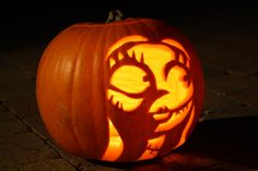 a carved pumpkin with an evil face on it