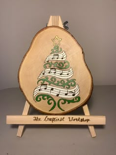 a wooden christmas tree with musical notes on it and the words, the cristerst workshop