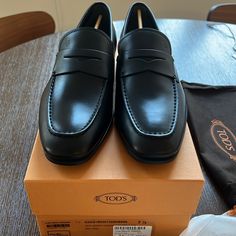 Tod’s Penny-Bar Loafers (Black - Uk 7.5 And Uk 7) Brand New, Never Worn. Purchased Different Sizes, But Didn’t Love The Fit. Designer Goodyear Welted Loafers For Workwear, Designer Round Toe Moccasins For Business Casual, Designer Moccasins With Round Toe For Business Casual, Timeless Black Wingtip Loafers, Designer Fitted Loafers For Semi-formal Occasions, Designer Semi-formal Loafers, Designer Leather Sole Loafers, Classic Formal Loafers With Branded Heel Counter, Designer Fitted Loafers With Leather Sole