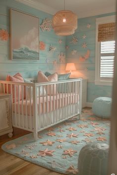 a baby's room decorated in pastel blue and pink with starfish wallpaper