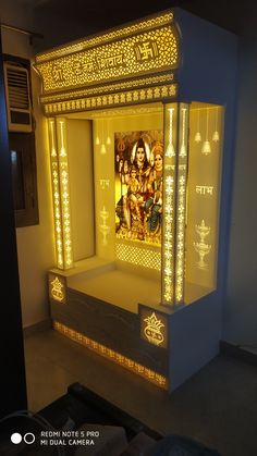 an illuminated shrine in the corner of a room