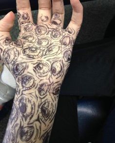 a person's hand with tattoos on it