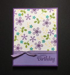 a purple and green birthday card on a black surface with the words, happy birthday