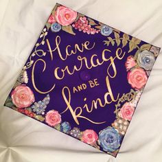 a purple graduation cap that says, have courage and be kind on it with flowers