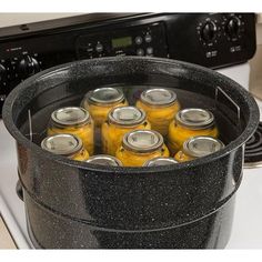 a pot full of yellow jars sitting on top of a stove