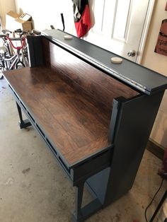 a desk that is sitting in the middle of a room with bikes parked behind it