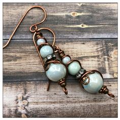 Handmade By Myself, These Lovely Earrings Are Part Of My Shes-A-Belle Line. Crafted From Antique Copper Components And Opalescent Pale Green Beads, Wire Wrapped, And Hammered. Earrings Measure 2” Long. Handcrafted In Denver, Co, Each Pair Will Come In A Custom Designed Display Card, And In A Small Gift Box. Check Out Additional Products At Www.Shesabelledesigns.Com. Be Sure To Like My Facebook Page At Www.Facebook.Com/Shesabelledesigns:) Funky Handmade Jewelry, Handmade Wire Jewelry Earrings, Crystal Bead Jewelry Ideas, Boho Dangle Earrings, Display Earrings For Sale, Asymmetrical Earrings Handmade, Wire Wrapped Hoop Earrings, Christmas Wire Jewelry, Wire Bead Jewelry