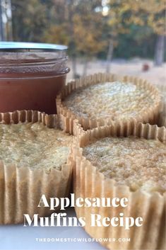 some muffins are sitting on a table next to a jar