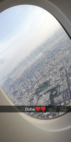 an airplane window with the view of a city