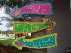 there are many signs hanging from the palm tree in front of this house that say tiki bar, pool party, chillin and tiki