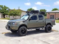 a green truck parked in a parking lot