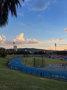 an outdoor track and field with people on it