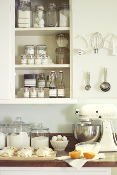 a kitchen counter with various items on it, including an electric mixer and blender