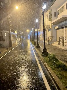 an empty street at night in the rain