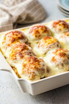 a casserole dish filled with meatballs and cheese