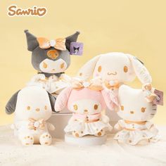 three stuffed animals sitting next to each other in front of a yellow background with the caption sanrio