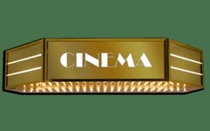 a golden sign with the word cinema on it's side and lights in front of it