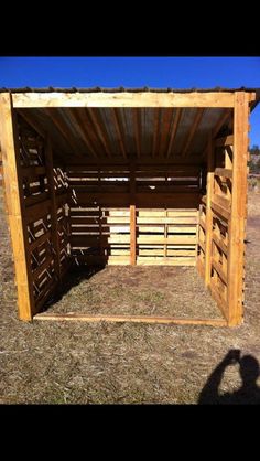 the inside of a wooden shed with wood slats on it's sides and doors open