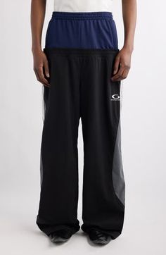 This season's playfully layered aesthetic informs the spliced style of superbaggy track pants finished with sporty side stripes. Elastic waist Side welt pockets; back welt pocket 100% polyester with 64% polyamide, 36% cotton contrast Dry clean Made in Italy Designer Clothing Side Stripe, Welt Pockets, Welt Pocket, Bottoms Pants, Track Pants, Balenciaga, Designer Clothing, Elastic Waist, In Italy